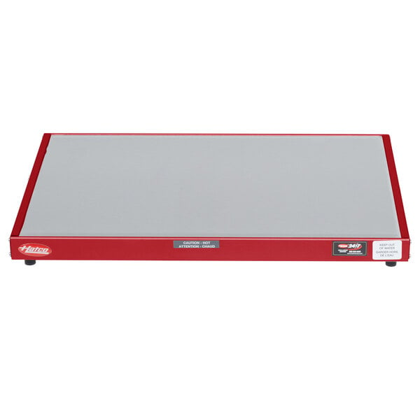 A white rectangular Hatco heated shelf with a red scale and white border.