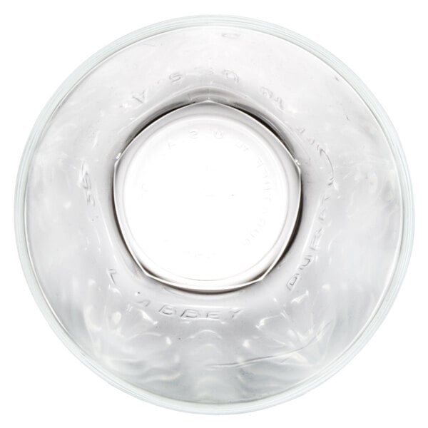 A close-up of a Libbey Inverness beverage glass with a circular bottom.