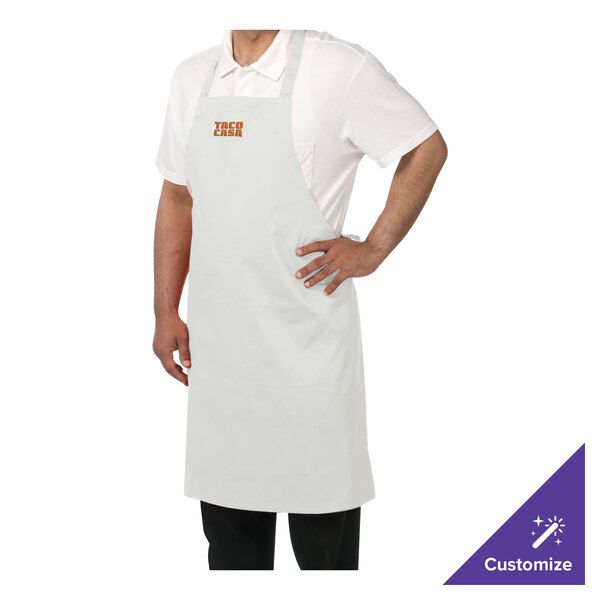 A man wearing a white Chef Revival bib apron with custom embroidery.