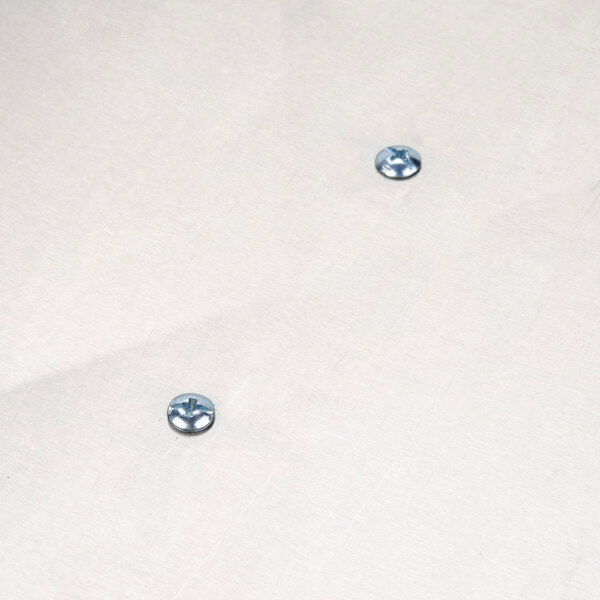 A white tank cover with two screw holes.