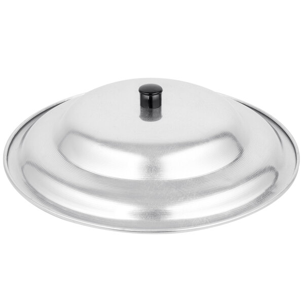 A silver aluminum wok cover with a black knob.