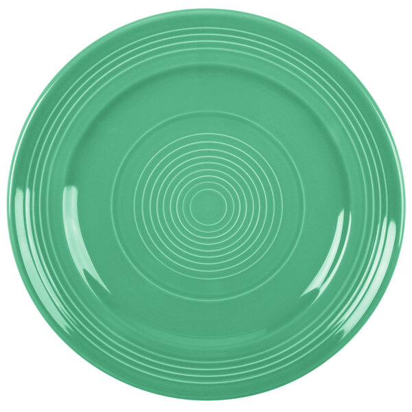 A green Tuxton Concentrix china plate with a white spiral pattern.