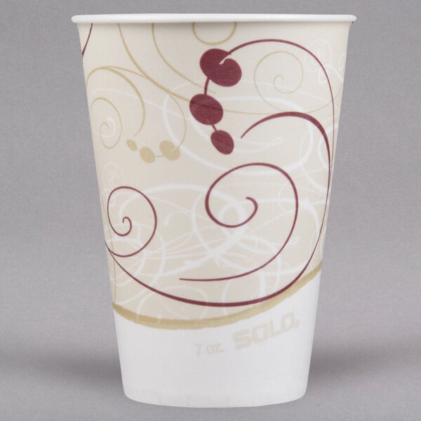 A white Solo paper cold cup with red swirl designs.