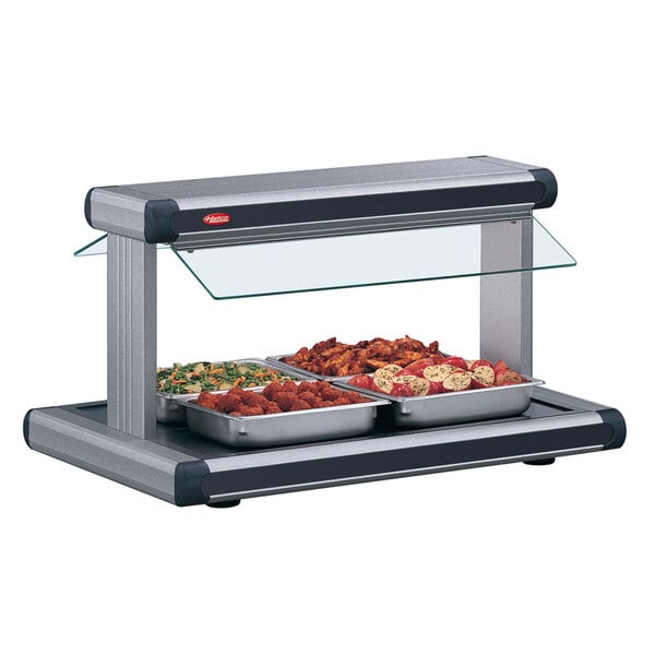 A Hatco buffet warmer with food on a black tray.