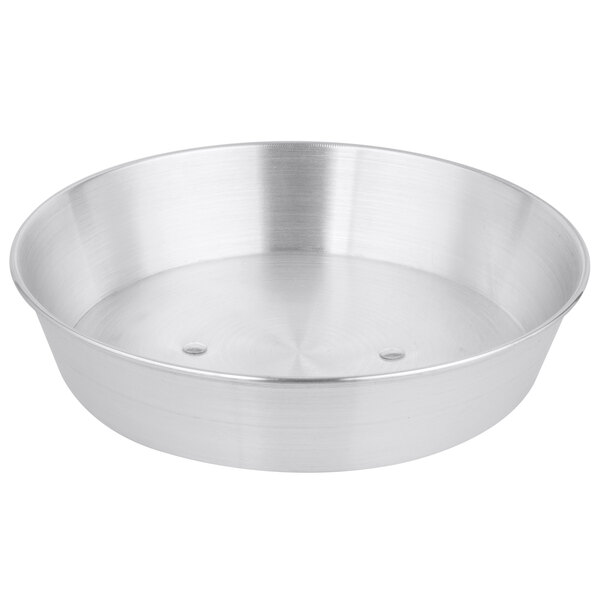 A silver aluminum wok cover with a circular pattern of holes.