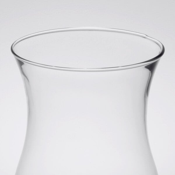 A close-up of a clear glass hurricane shade.