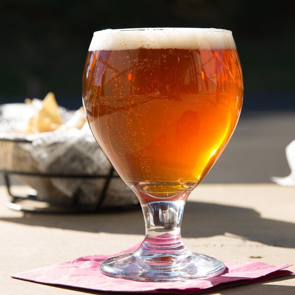 Goblet-shaped beer glass filled with amber-colored beer