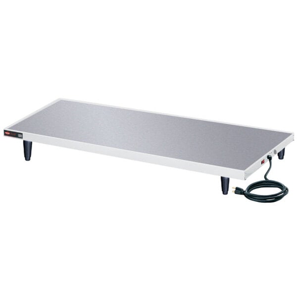 A white rectangular Hatco heated shelf with black power cords.