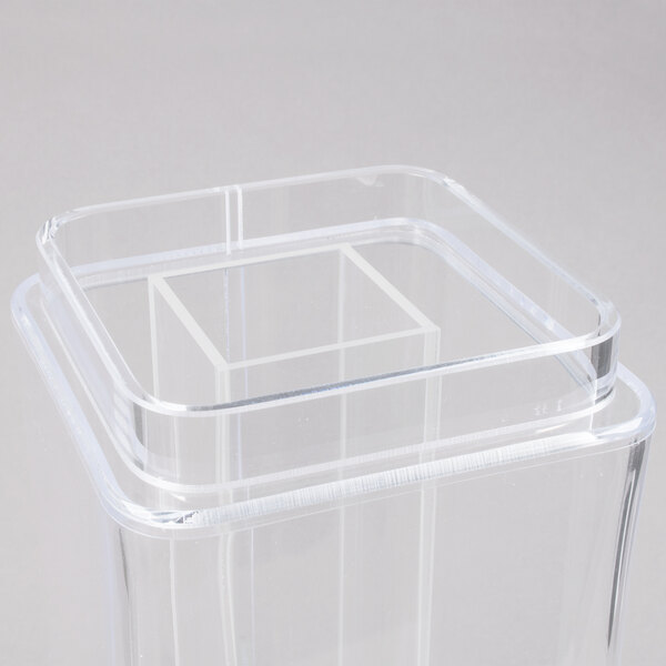 A clear plastic square beverage dispenser with a lid on top.