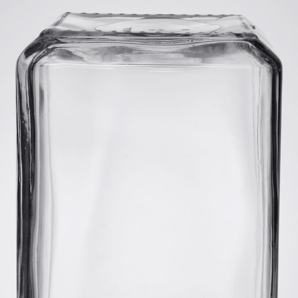 An Anchor Hocking clear square glass jar with a brushed aluminum lid.