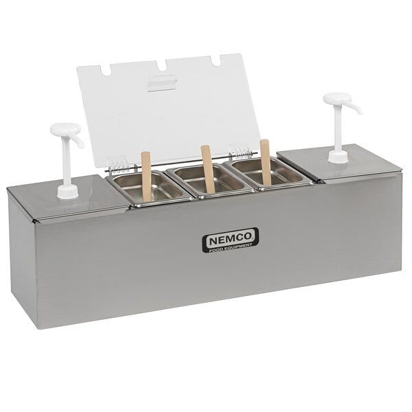 A Nemco stainless steel condiment bar with pumps and condiment trays on a counter.