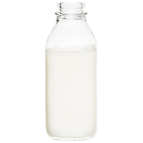 A Libbey glass milk bottle filled with milk.