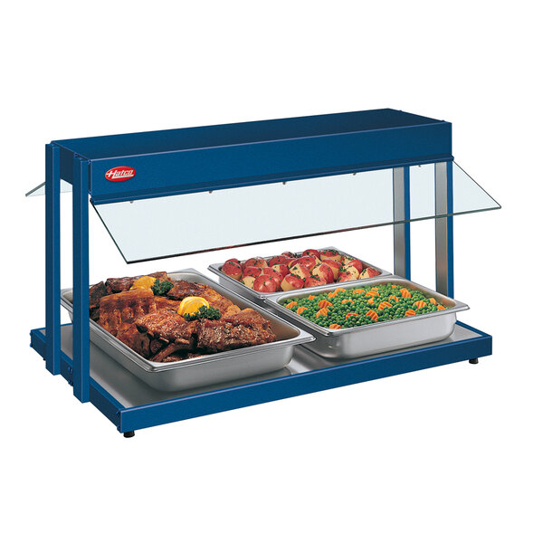 A Hatco navy blue buffet warmer with trays of food inside.