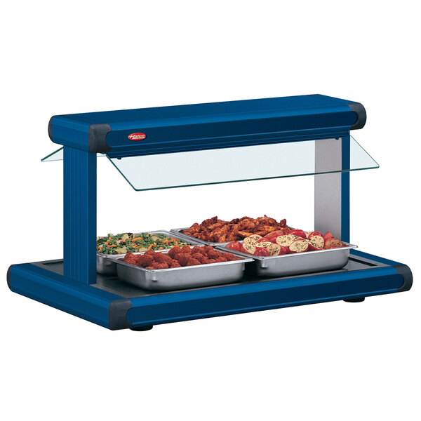 A navy blue Hatco buffet warmer with navy blue insets holding food on a buffet table.