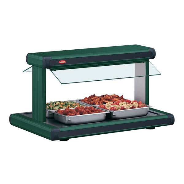 A Hatco green buffet food warmer with black insets holding food on a counter.