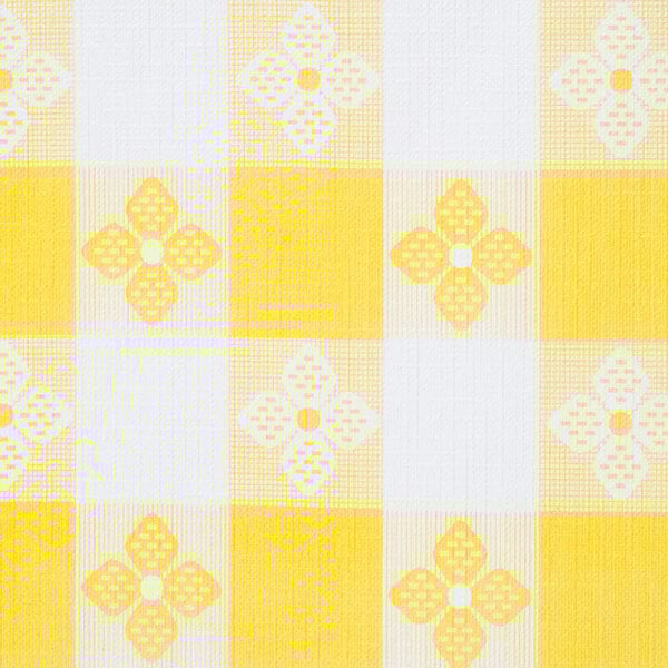 A yellow and white checkered tablecloth with flowers.