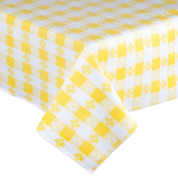 A yellow and white checkered Intedge vinyl table cover on a table.