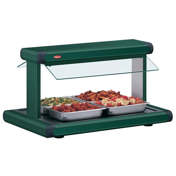 A Hatco Hunter Green buffet food warmer with food in it on a table.