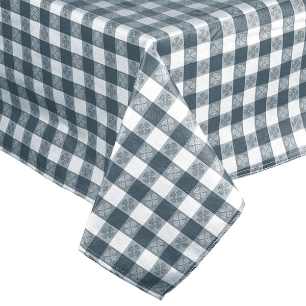 A blue gingham vinyl table cover with a checkered pattern on a table.