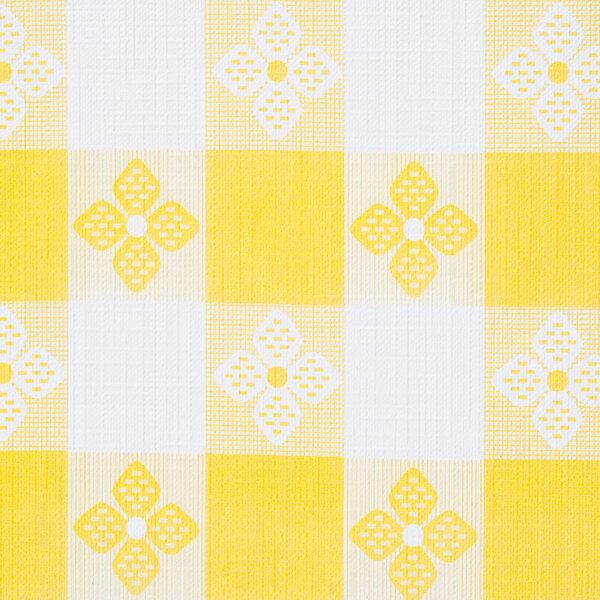 A yellow and white checkered tablecloth with flowers.