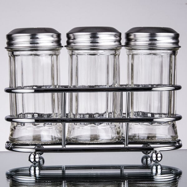 A Tablecraft fluted glass condiment shaker set on a metal rack.
