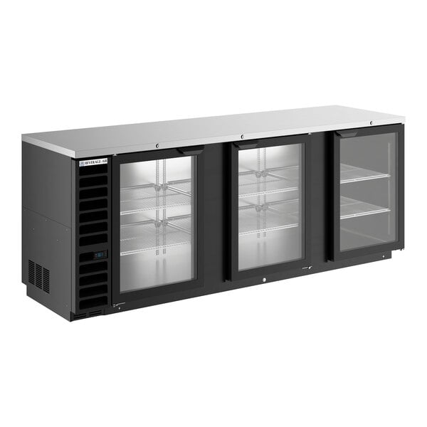 A large black counter height back bar refrigerator with three glass doors and metal shelving.