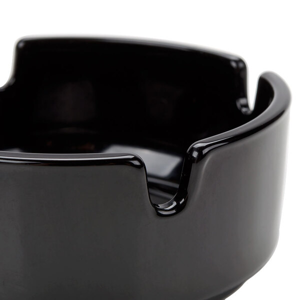 An Arcoroc black round glass ashtray.