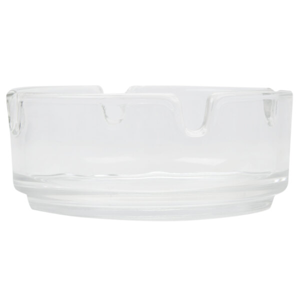 A close-up of a clear glass Arcoroc ashtray.