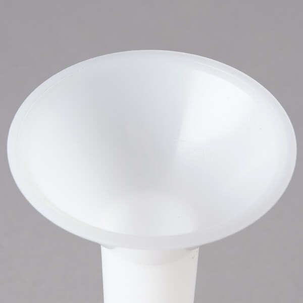 A white plastic cylinder with a small hole in the middle.