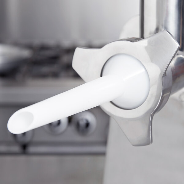 A stainless steel Vollrath sausage stuffer tube with a white attachment.
