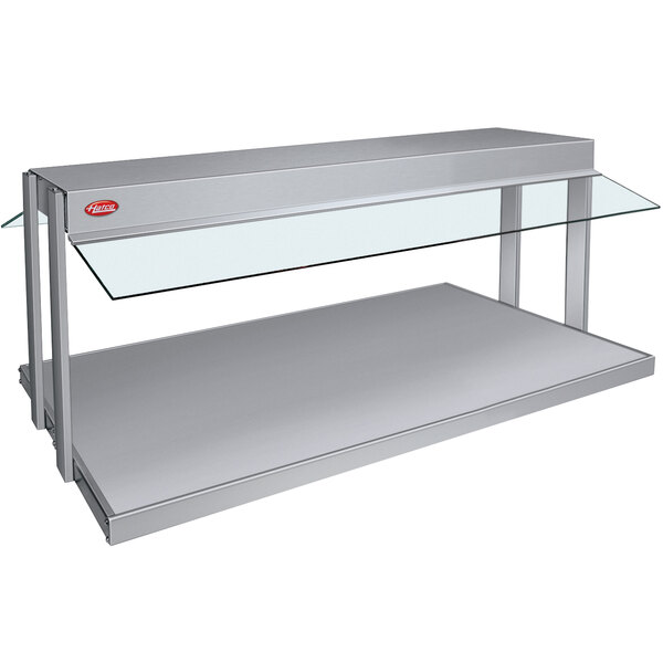 A stainless steel countertop buffet warmer with glass top.
