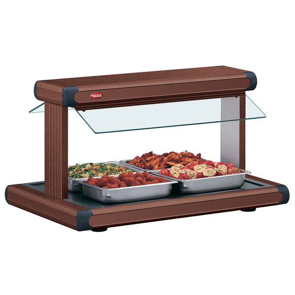 A Hatco buffet warmer with food in it on a buffet table.