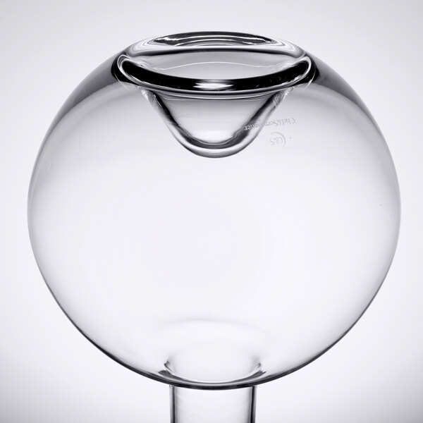 A clear glass sphere with a small hole in the bottom.