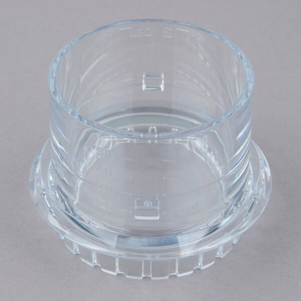 A clear plastic container with a round base and a lid.