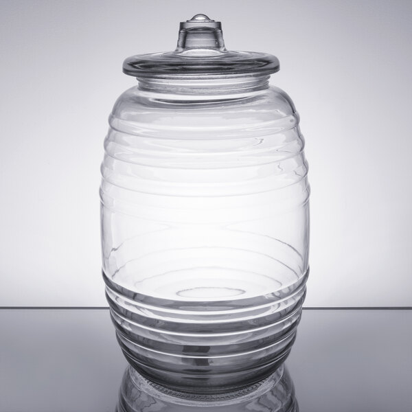 A clear Libbey barrel jar with a lid.
