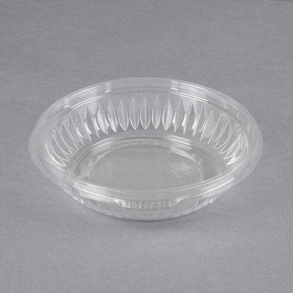 a clear plastic bowl on a gray surface