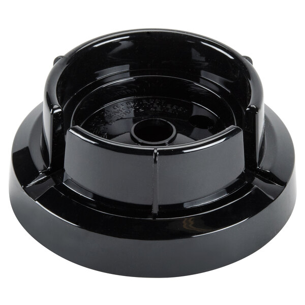A black plastic Waring blender jar adapter.