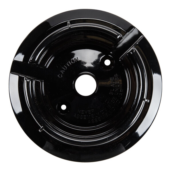 A black circular plate with holes in it.