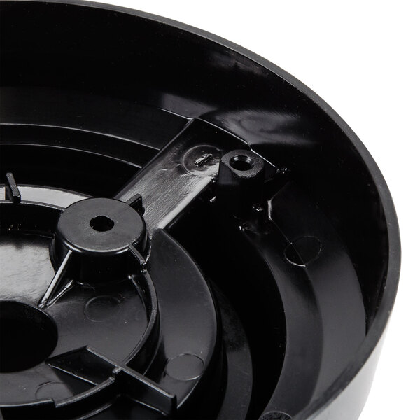 A black circular blender jar adapter with a metal gear.