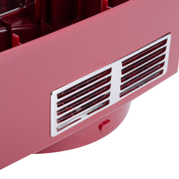 A red plastic motor support with a vent.