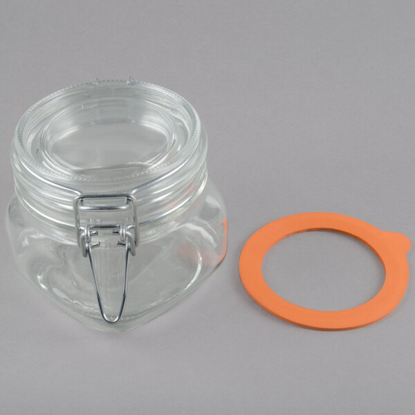A black rustic jar condiment display with a glass jar with a white lid and an orange circle on the lid.