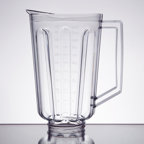 A clear plastic Hamilton Beach blender container with handle.