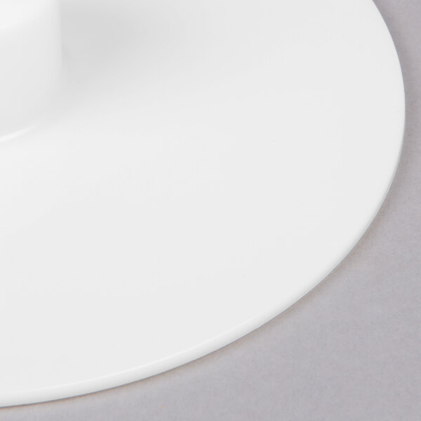 A white Robot Coupe discharge plate with a circular hole in the center.