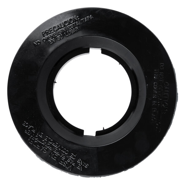 A black circular cover with a hole in it.