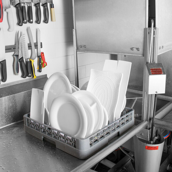 A dishwasher with Carlisle white melamine plates in it.