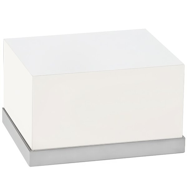 A white rectangular riser with a stainless steel base.