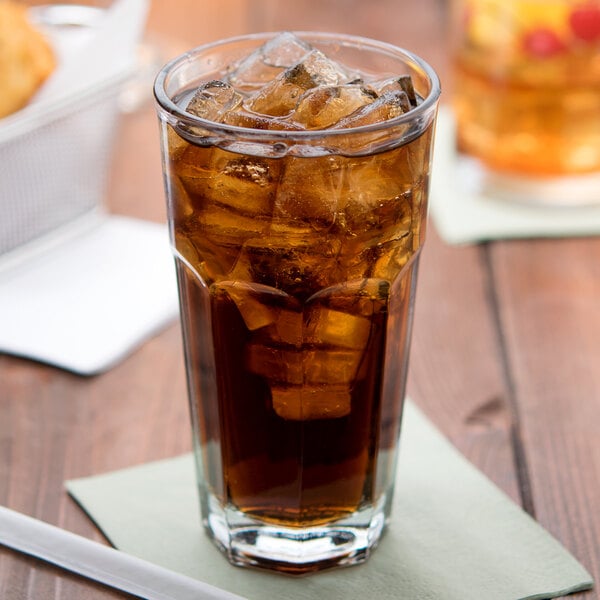 A glass of ice tea with ice cubes in an Anchor Hocking New Orleans Cooler Glass.