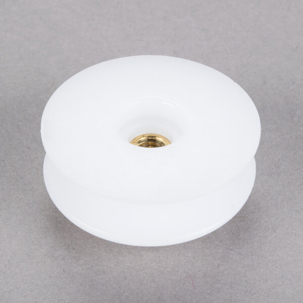 A white plastic threaded actuator knob with a gold screw.
