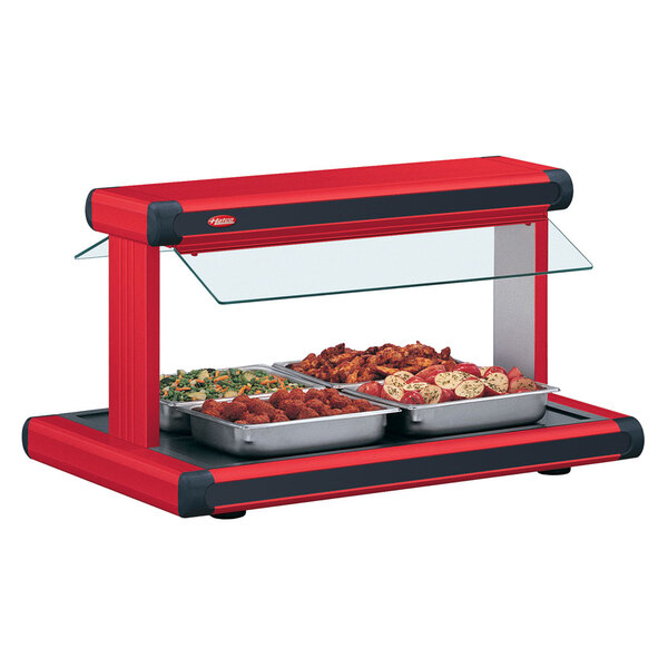 A red Hatco Glo-Ray countertop buffet warmer with black insets over trays of food.