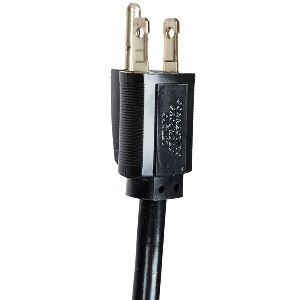 A black electrical cord with two gold plugs.